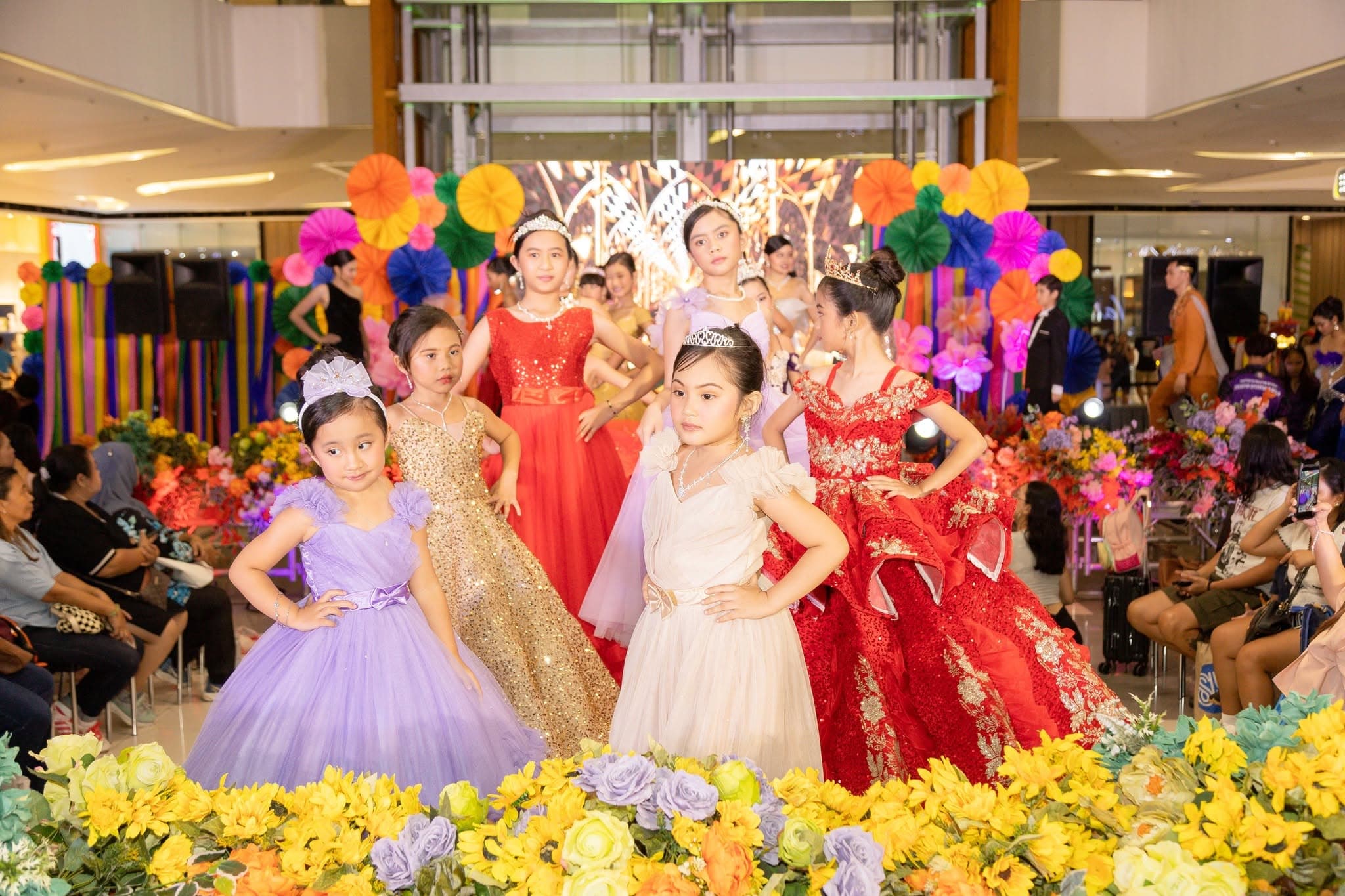 Young Jngels models in ball gowns at a mall show