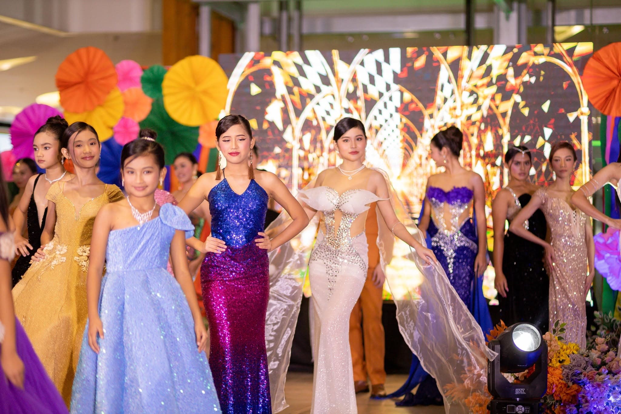 Jngels models in evening gowns during a fashion show