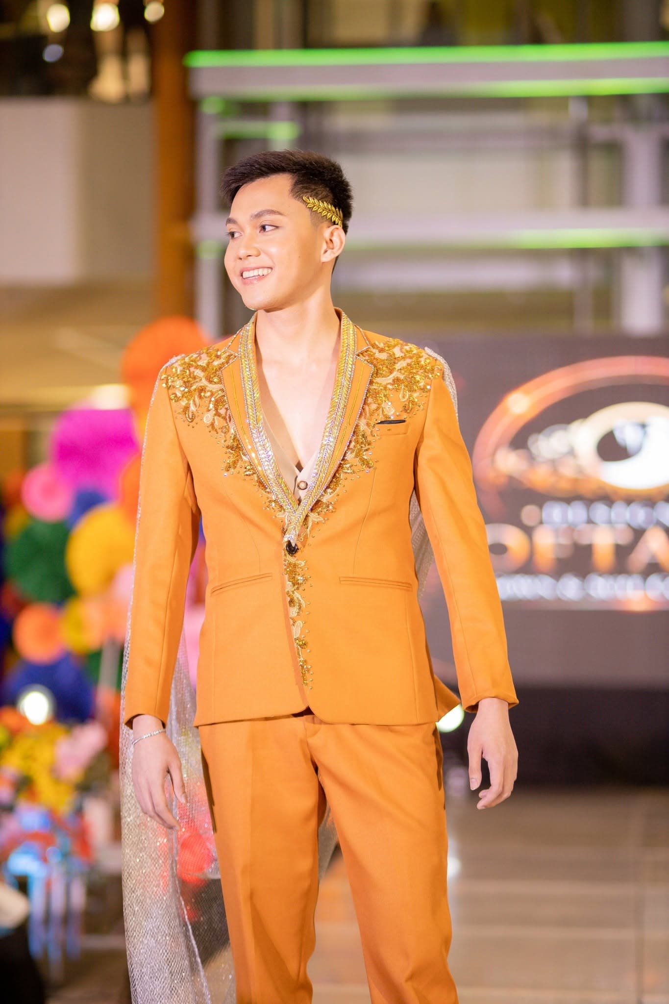 Jngels male model in a gold embroidered suit
