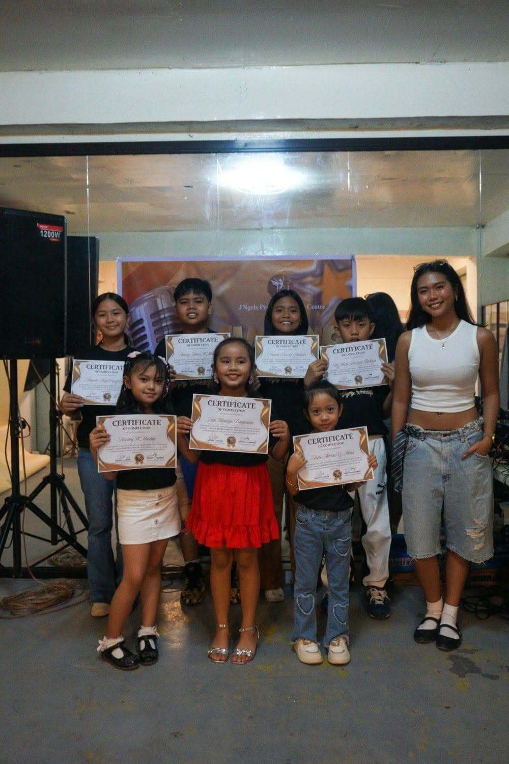 Singing class graduates with certificates